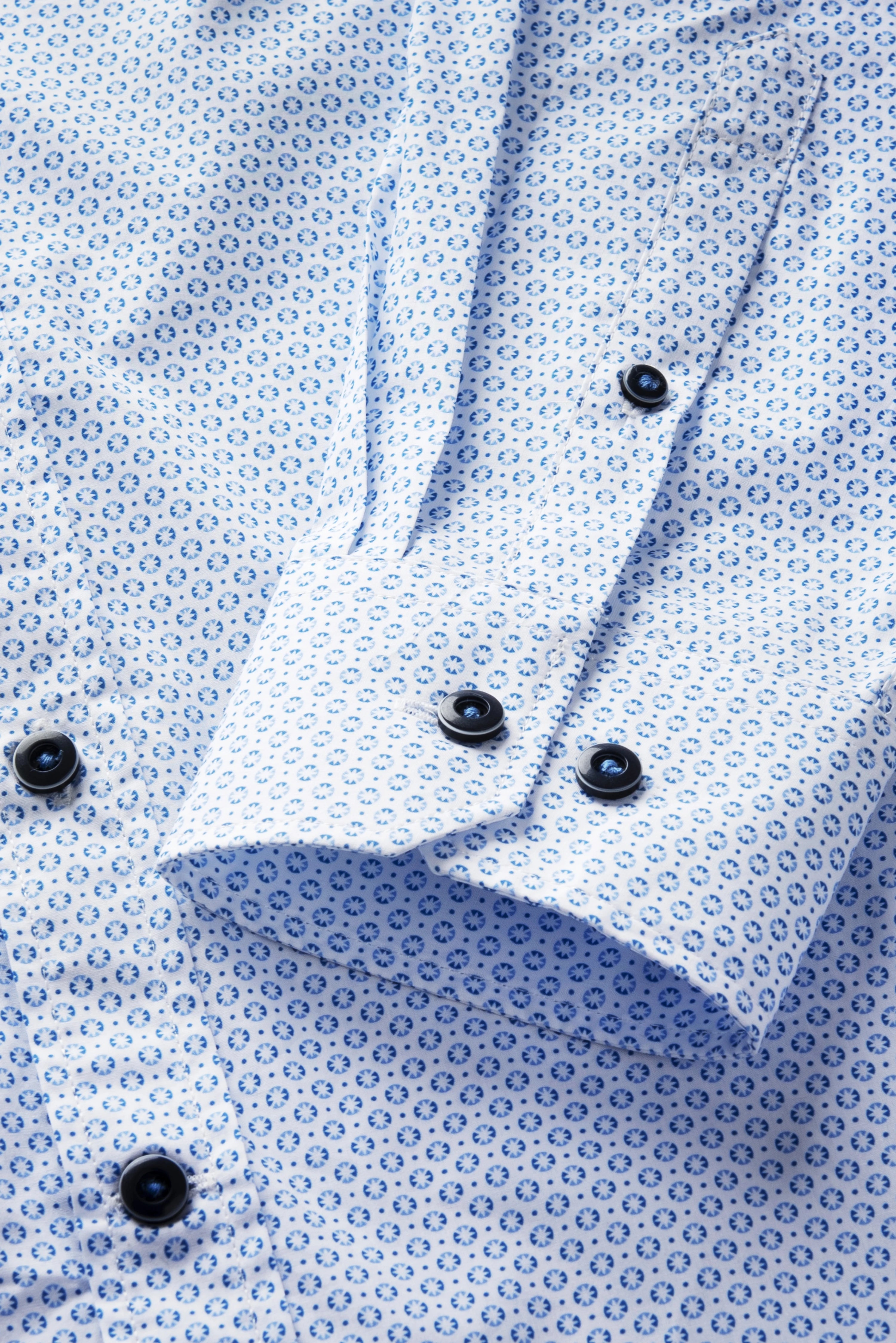 Blauw-wit bugatti overhemd met bloemenpatroon, close-up van de manchet.