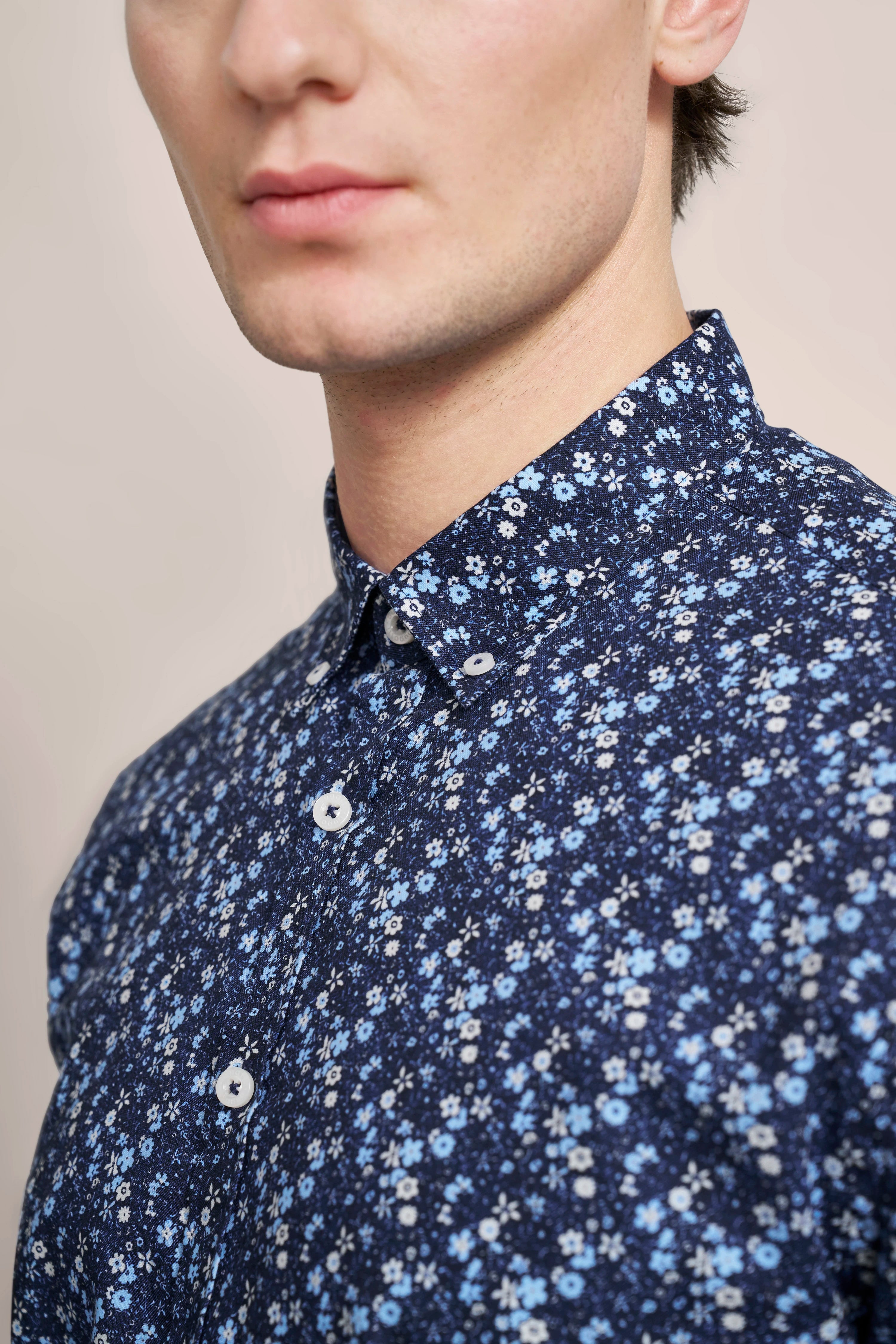 Büstenbild mit floralem Hemd in Blau und Weiß von bugatti, stilvoll und elegant.