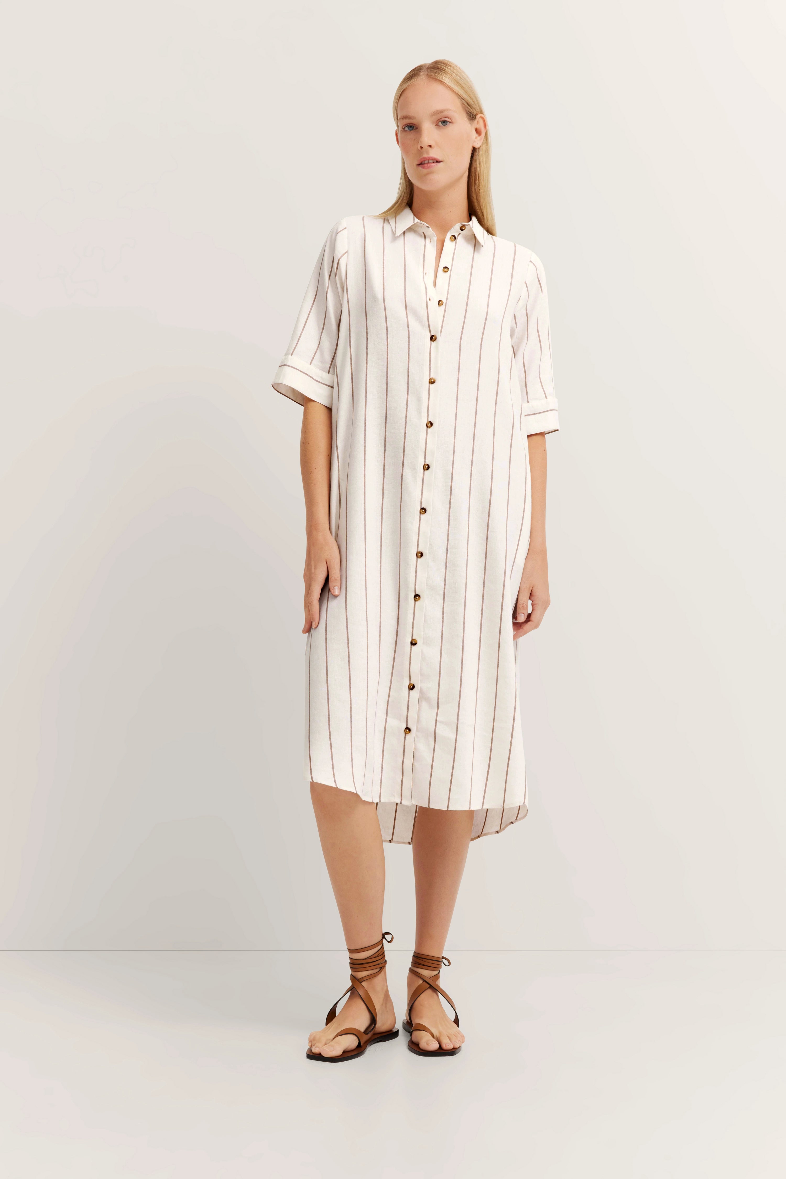 White shirt dress with brown stripes, model in relaxed pose, bugatti style.