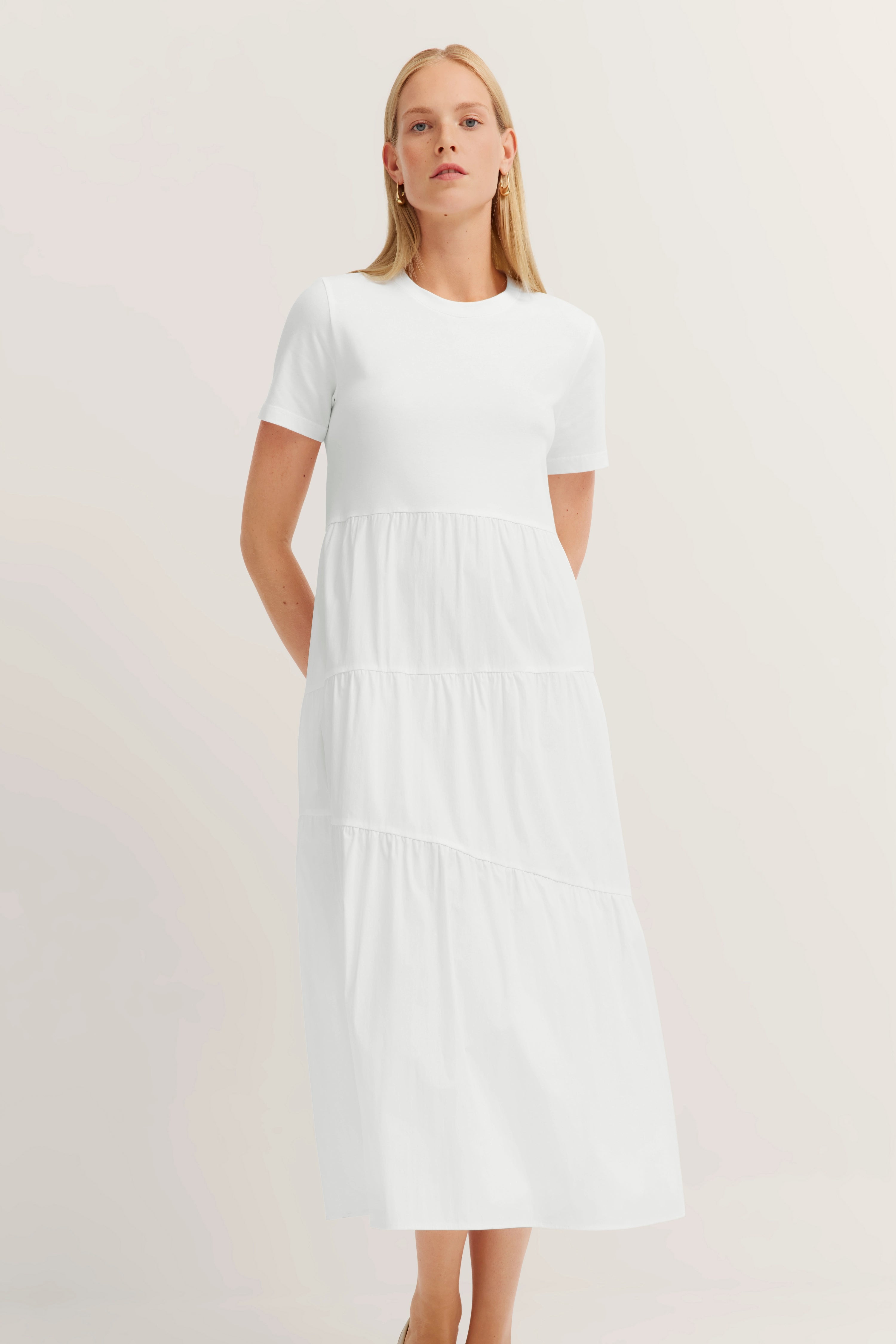 White bugatti dress, short sleeve, model pose, timeless elegance.