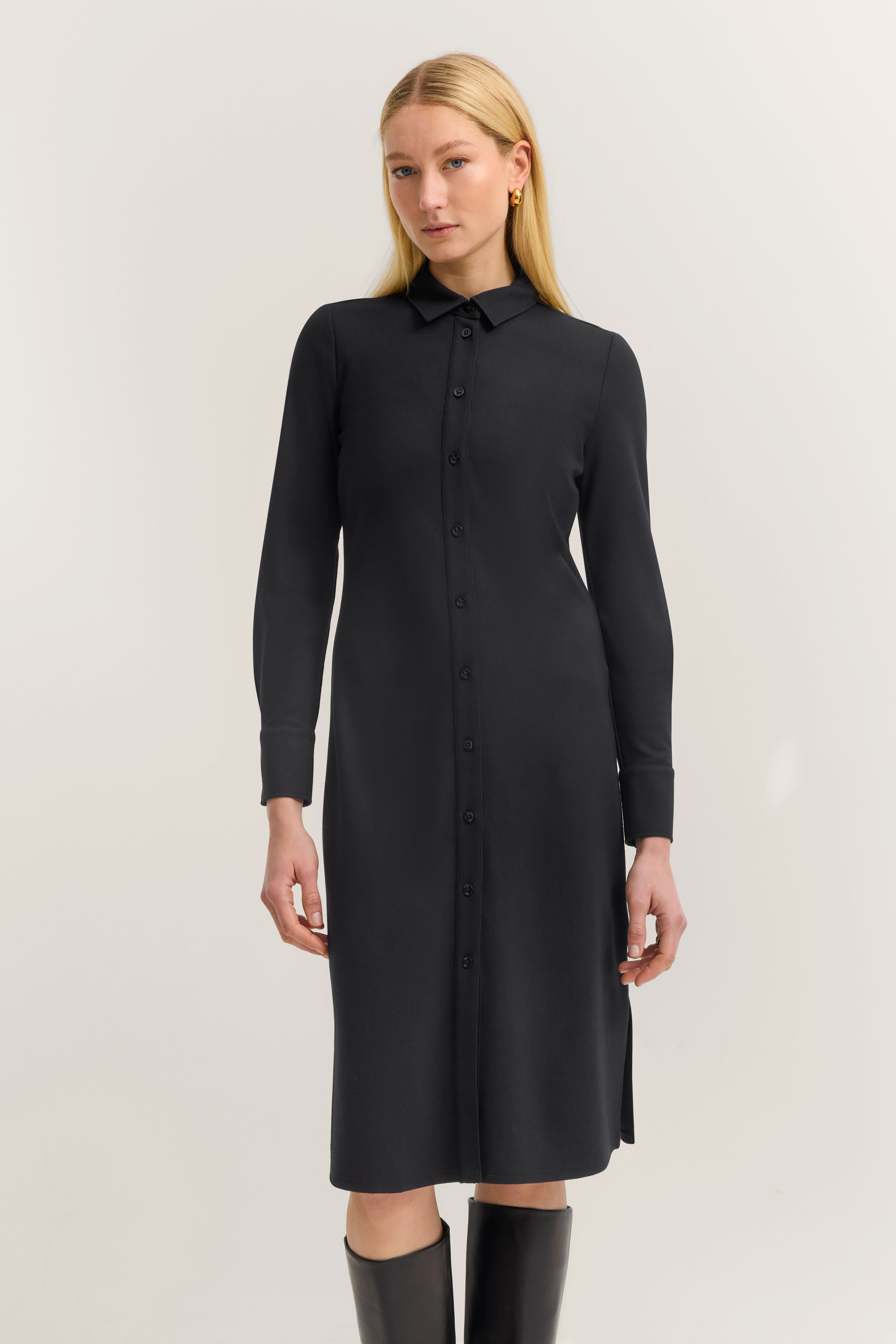 Black bugatti shirt dress, model standing, timeless elegance.