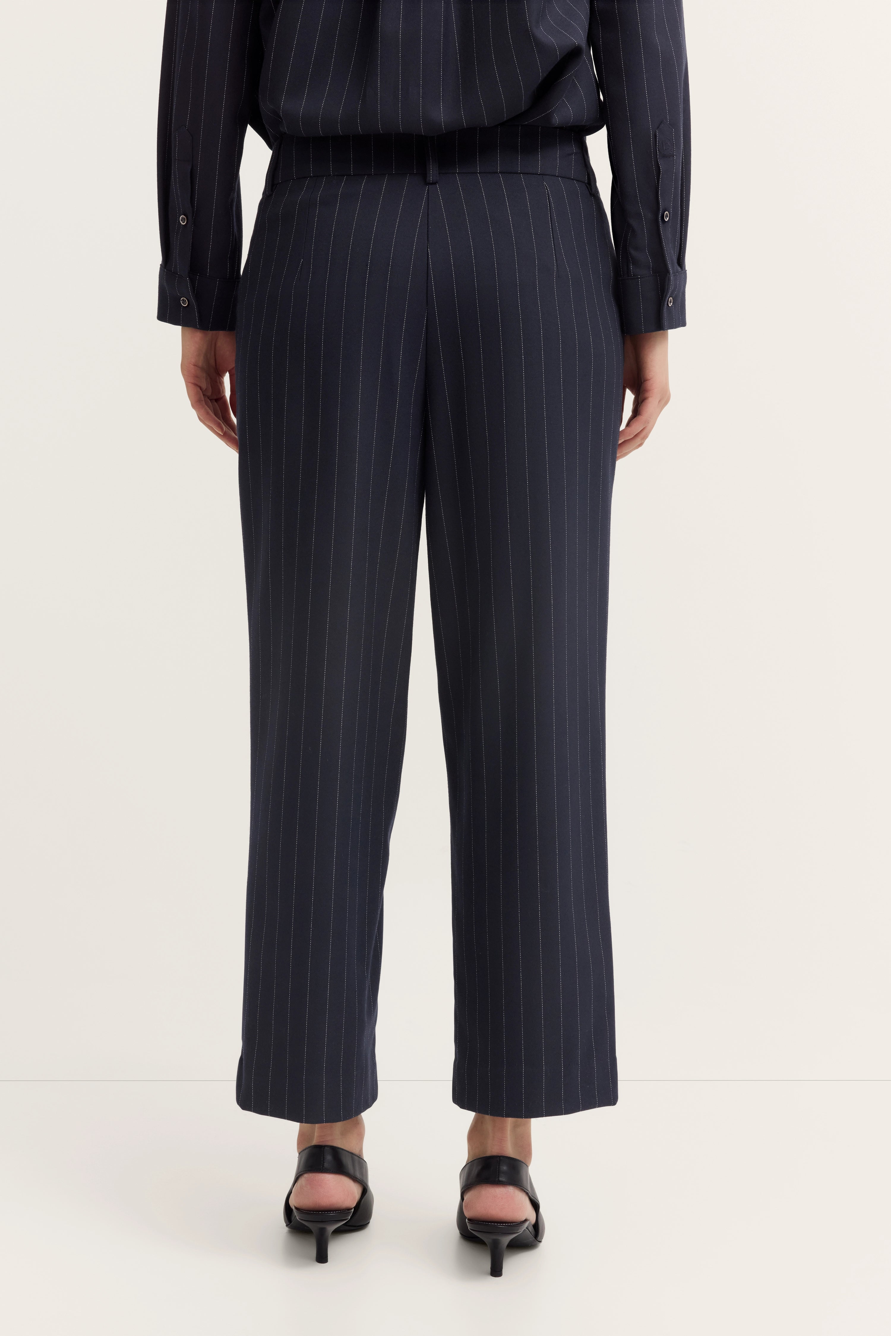 Navy gestreifte Hose von bugatti, Modelbild, Rückansicht, Posing stehend, elegante schwarze Schuhe.